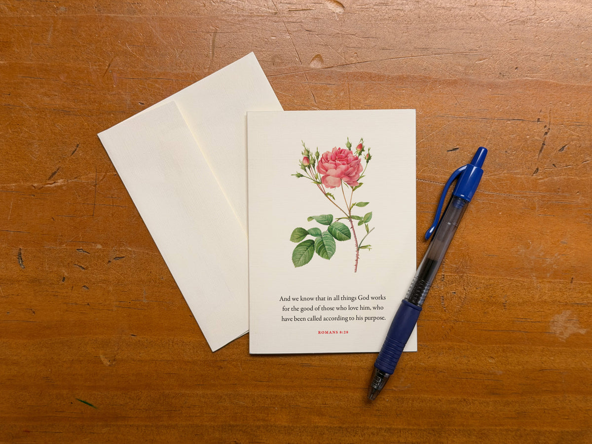 Romans 8:28 Bible verse card shown handwritten